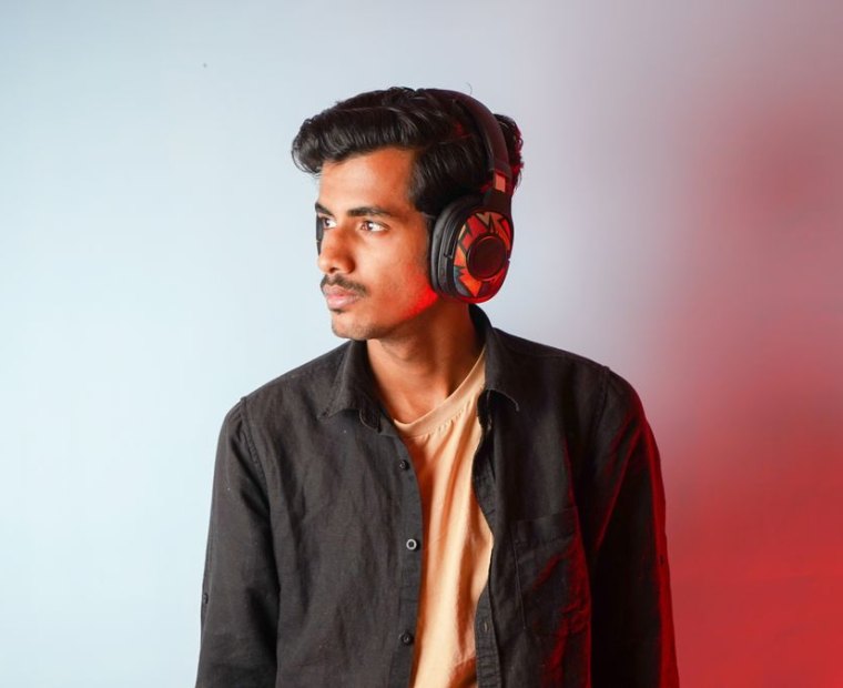 A young artist listening back on studio headphones