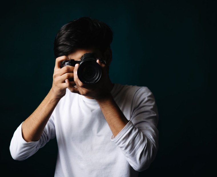 A camera operator framing a shot